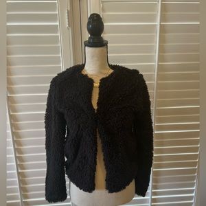 H&M fuzzy little jacket. Light, but fluffy. Slight shimmer in the fabric.